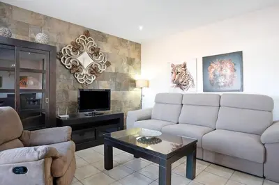 a living room with a couch and a tv at Casa Borpa - Solo Familias in Conil de la Frontera