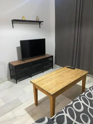a living room with a tv and a coffee table at Casa Ana in Jerez de la Frontera