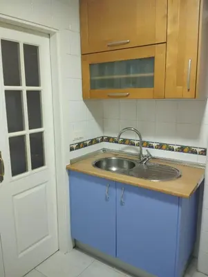 a kitchen with a sink and a blue cabinet at Casa Ana in Jerez de la Frontera
