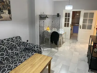 a living room with a couch and a table at Casa Ana in Jerez de la Frontera