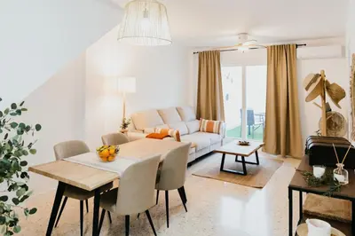 a living room with a table and a couch at Casa Bahía in El Puerto de Santa María