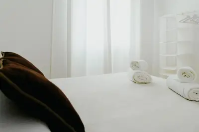 a pile of towels sitting on top of a bed at Casa Bahía in El Puerto de Santa María
