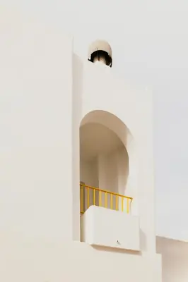 a staircase in a white building with a window at Casa Bahía in El Puerto de Santa María