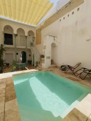 a large swimming pool in a large building with a ceiling at casa la zarzamora in Jerez de la Frontera