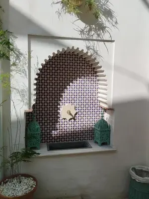 a wall with a wooden arch in a room at casa la zarzamora in Jerez de la Frontera