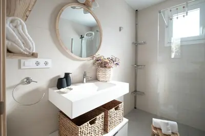a bathroom with a white sink and a mirror at Tío Pa - Tucasaenconil in Roche