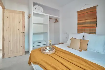 a bedroom with a bed with a basket on it at Tío Pa - Tucasaenconil in Roche