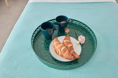 a plate with a croissant and two cups on a table at Tío Pa - Tucasaenconil in Roche