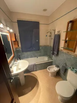 a bathroom with a sink and a toilet and a tub at Villa Bolet in Chiclana de la Frontera