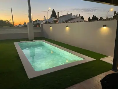 a swimming pool on the roof of a house at Villa Bolet in Chiclana de la Frontera