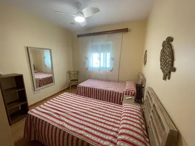 a bedroom with two beds and a mirror at Villa Bolet in Chiclana de la Frontera