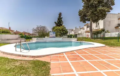 a swimming pool in a yard with a brick ground at Pet Friendly Apartment in El Puerto de Santa María