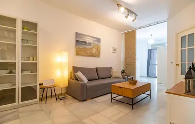 a living room with a couch and a table at Pet Friendly Apartment in El Puerto de Santa María