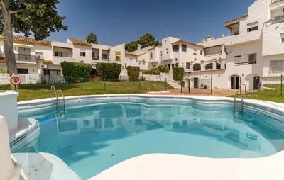 a large swimming pool in front of a building at Pet Friendly Apartment in El Puerto de Santa María