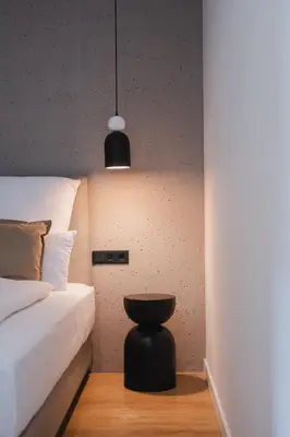 a bedroom with a bed and a black stool at Casa Cuatro Boutique Hotel - Adults Recommended in Novo Sancti Petri