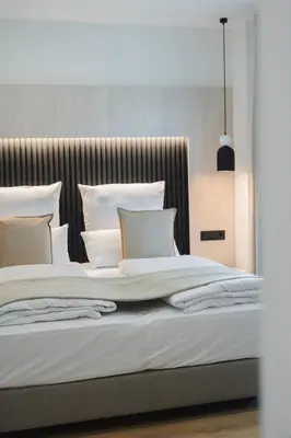a bedroom with a large bed with white pillows at Casa Cuatro Boutique Hotel - Adults Recommended in Novo Sancti Petri