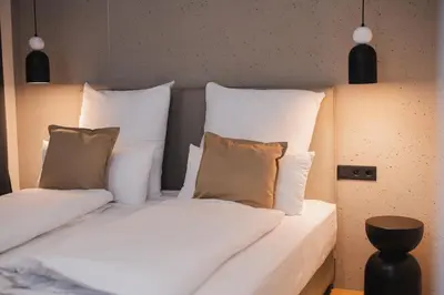 two beds in a room with white pillows at Casa Cuatro Boutique Hotel - Adults Recommended in Novo Sancti Petri