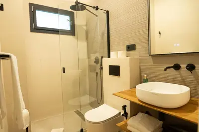 a bathroom with a sink and a shower and a toilet at Casa Cuatro Boutique Hotel - Adults Recommended in Novo Sancti Petri