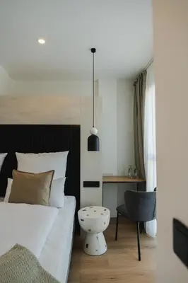 a bedroom with a bed and a desk and a chair at Casa Cuatro Boutique Hotel - Adults Recommended in Novo Sancti Petri