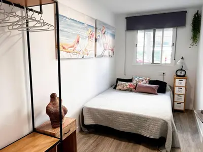 a bedroom with a bed and a mirror at Casa Moderna con Garaje en Rota, cerca de Playa in Rota