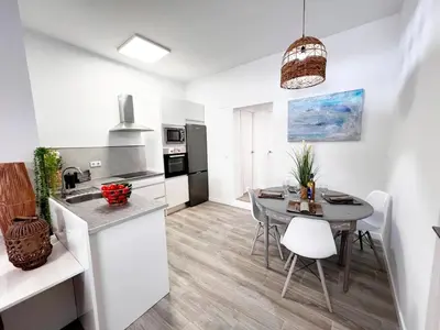 a kitchen and dining room with a table and chairs at Casa Moderna con Garaje en Rota, cerca de Playa in Rota