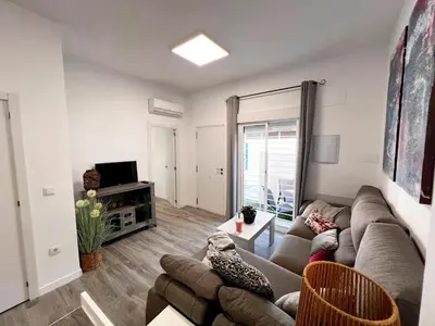 a living room with a couch and a tv at Casa Moderna con Garaje en Rota, cerca de Playa in Rota