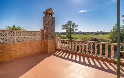 a balcony of a house with a brick pillar at Stunning Home In Chiclana De La Fronter in Novo Sancti Petri