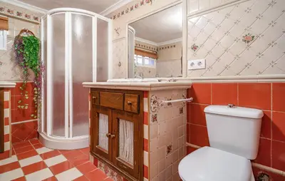 a bathroom with a toilet and a sink and a mirror at Stunning Home In Chiclana De La Fronter in Novo Sancti Petri