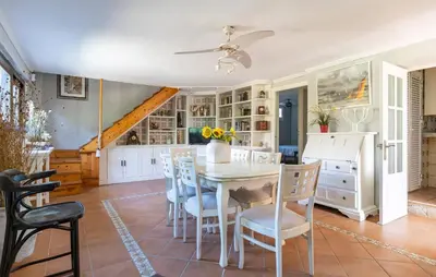 a dining room with a white table and chairs at Stunning Home In Chiclana De La Fronter in Novo Sancti Petri