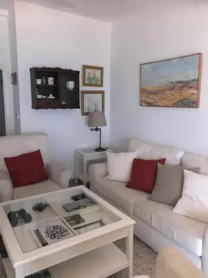 a living room with two couches and a coffee table at Apartamento primera linea de playa in Rota