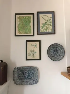 a wall with three framed pictures on a wall at Apartamento primera linea de playa in Rota