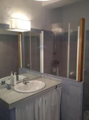 a bathroom with a white sink and a shower at Apartamento primera linea de playa in Rota