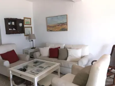 a living room with a couch and a coffee table at Apartamento primera linea de playa in Rota