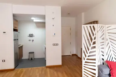 a living room with a staircase and a room with white walls at Norte y Sur by Gades Gestión in San Fernando