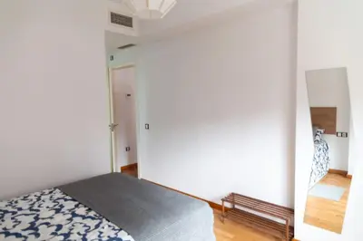 a bedroom with a bed and a mirror at Norte y Sur by Gades Gestión in San Fernando