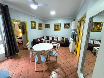 a living room with a table and chairs and a couch at Cielos Casona in El Puerto de Santa María