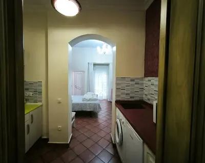 a kitchen with an archway leading to a bedroom at Cielos Casona in El Puerto de Santa María