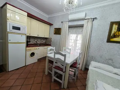 a kitchen with a table and a dining room at Cielos Casona in El Puerto de Santa María