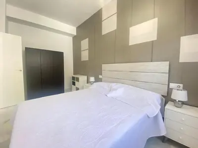 a bedroom with a large white bed with white sheets at People Homes Clavel in Jerez de la Frontera