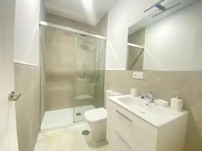 a bathroom with a shower and a toilet and a sink at People Homes Clavel in Jerez de la Frontera