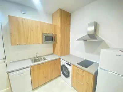 a small kitchen with a sink and a washer at People Homes Clavel in Jerez de la Frontera
