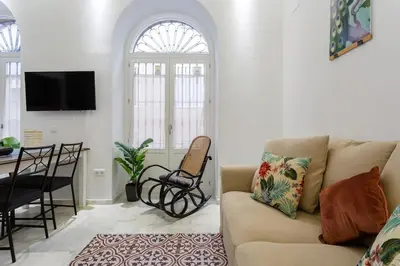 a living room with a couch and a table at Apartamento Miracadiz in Cádiz