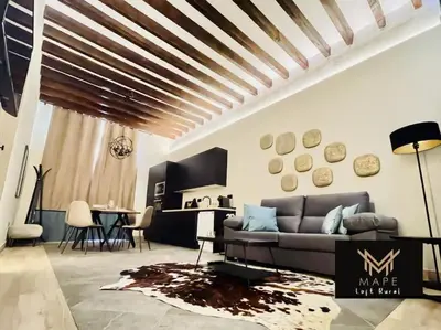a living room with a couch and a table at Winahost Algar Rural in Algar