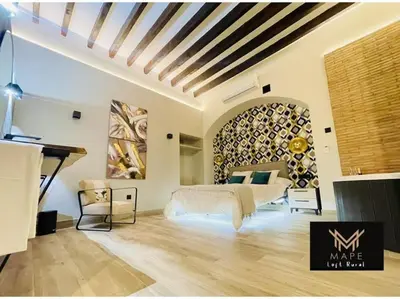 a bedroom with a bed and a large painting on the wall at Winahost Algar Rural in Algar