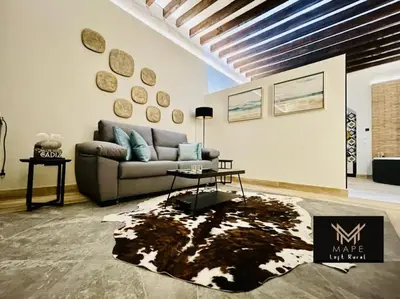a living room with a couch and a table at Winahost Algar Rural in Algar