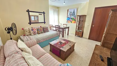 a living room with a couch and a table at Chocita del Botánico Pet Friendly by Sanlúcar Housing in Sanlúcar de Barrameda