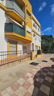 a yellow and white building with a balcony at Chocita del Botánico Pet Friendly by Sanlúcar Housing in Sanlúcar de Barrameda