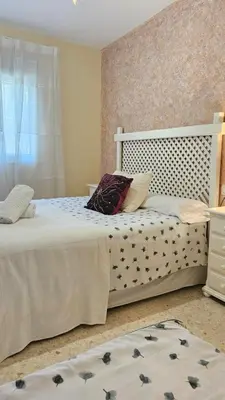 a bedroom with two beds with pillows on them at Chocita del Botánico Pet Friendly by Sanlúcar Housing in Sanlúcar de Barrameda