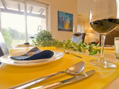 a table with a glass of wine and some silverware at Villa 210 by Villamya in Arcos de la Frontera