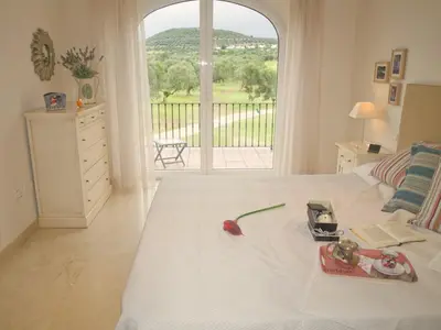 a bedroom with a white bed with a large window at Villa 210 by Villamya in Arcos de la Frontera